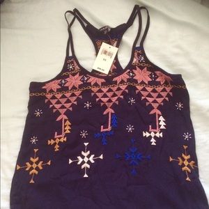 Beautifully embroidered racer back tank top.